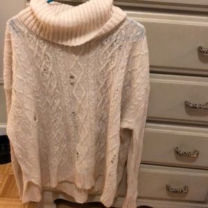 Distressed cable knit sweater